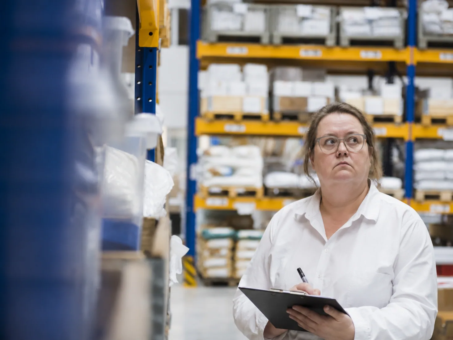 QA professional reviewing a temperature-controlled warehouse